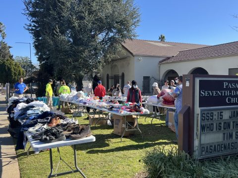Volunteers, including those from Gideon Rescue Co., distribute clothing and food at Pasadena church.