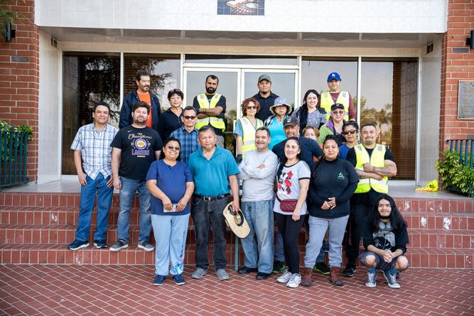 Volunteers—some who have been helping out for the whole day gather for a photo after the food bank closes and tear-down is complete.