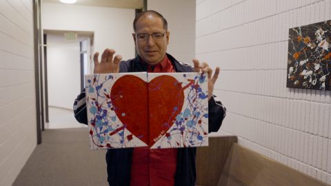 Gerardo Rivas displays his “splatter paintings.”