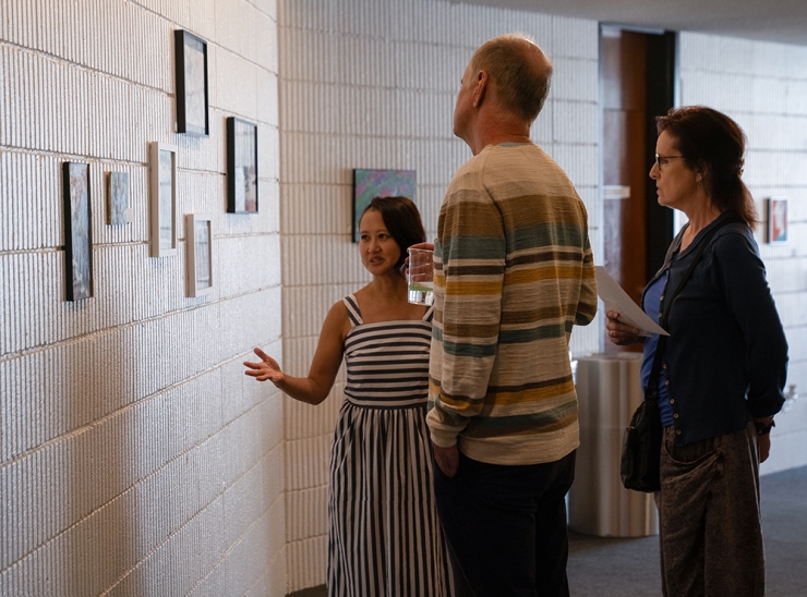 Mae Chinn shares information about the artwork with some visitors.