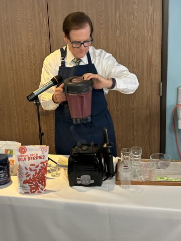 Westerdahl finishes making an Anti-Aging smoothie that had participants eager for second samples.