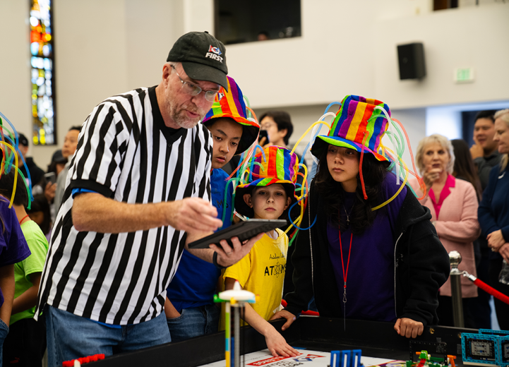 Members from Antelope Valley Atoms, Antelope Valley Adventist School’s robotics team, await results calculated during the competition.