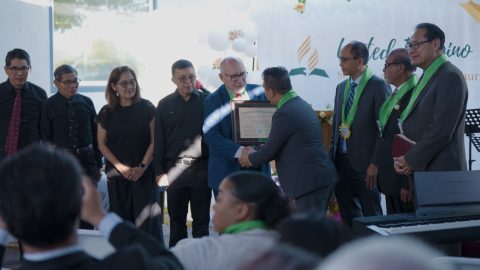 United Filipino company celebrates new company status with a certificate.